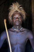 Young Himba man in his hut, Ohandungu, Kunene region, Kaokoveld, Namibia, Africa