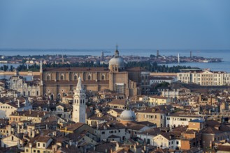 View over the roofs of Venice to the church Basilica dei Santi Giovanni e Paolo in the evening