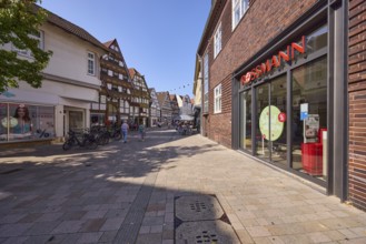 Pedestrian zone Lange Straße with a branch of the drugstore Rossmann, retail shops and