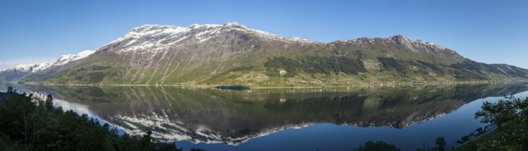 Morning sun over the Sørfjord, a branch of the Hardangerfjord, view from the apple plants at