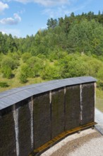 Curved wooden Kneipp wall in the middle of a wooded landscape, brine, graduation tower, spa town of