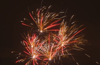 Fireworks with red and yellow sparks that glow in the dark, Lower Saxony, Germany, Europe