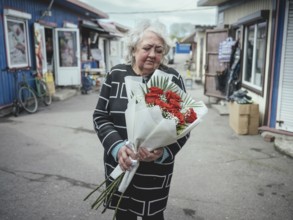 Valentina, 66, celebrates her birthday at the market, at lunchtime, when the shelling starts at 1