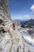 Mountaineer with helmet in a secured via ferrata, Zugspitz via ferrata, ascent to the Zugspitze,