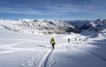 Ski tourers ascending Monte Cevedale, mountain panorama, snow-covered mountain landscape in winter,