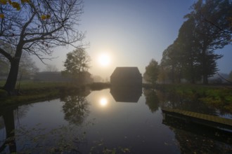 Morning sun over the estate pond on a foggy morning at Gut Othenstorf, Othenstorf near Rehna,