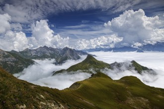 View from a mountain in Austria of an impressive mountain panorama with a sea of clouds and lush