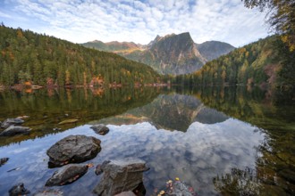 Mountain peaks of the Ötztal Alps reflected in Lake Piburger See, in autumn, near Ötz in Ötztal,