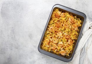 Pasta with shrimp and cheese, with a golden crust, cooked in a baking dish, homemade, no people