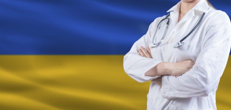 Doctor with crossed arms on Ukraine flag. Ukraine Health and Care concept. Female doctor on Ukraine