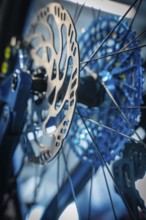 Close-up of a blue brake disc with spokes of a bicycle, Waldbike Manufaktur, bicycle workshop,