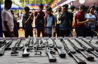 Students visit an arms stall during an exhibition to commemorate Assam Police Day, in Guwahati,