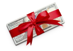 Stack of one hundred dollard bills wrapped in a red ribbon and bow isolated on a white background