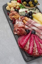 Appetizer, assortment, set, sausage, and cheese, on a wooden board, top view, no people