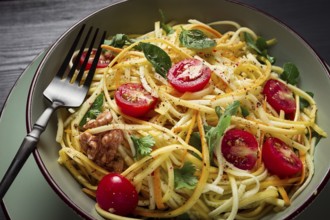 Yellow zucchini salad, with cherry, vegetarian food, sliced into strips, homemade