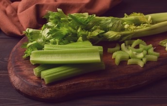 Fresh bunch of celery, top view, no people, on a dark background