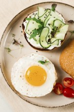 Assortment of sandwiches, white bread, fried egg, cream cheese and cucumber, capelin caviar, sesame