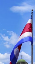 Costa Rica Flag proudly waving in San Jose. Large Costa Rica flag is flying high in city center