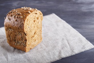 Cut rye bread on linen napkin. close up