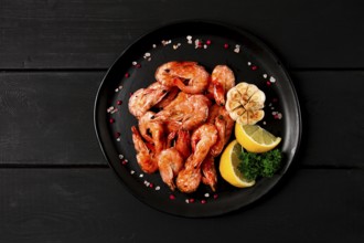 Fried shrimp, on a black background, top view, no people