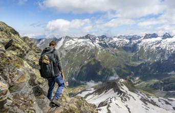 Mountaineers on a rope-insured hiking trail, breathtaking mountain landscape, view of Zemmgrund