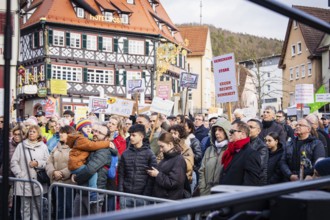 Demonstration participants with banners in a lively city scene, demonstration against the right,