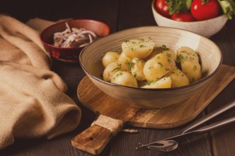 Fresh Cooked, new potatoes, with dill, on a wooden table, selective focus. close-up, toning, no