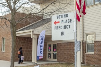 Deaarborn, Michigan USA, 27 February 2024, A voter and her child arrive to vote at Geer Park School