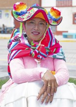 Peruvian woman, 20 years old, in traditional dress at the market in Cocotos on Lake Titicaca, Puno