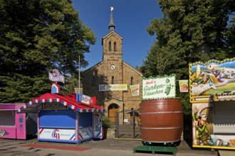 Cranger Kirche between closed fairground stalls in the morning, Cranger Kirmes, Herne, Ruhr area,