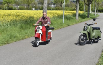 Man rides a Troll 1 vintage scooter in spring