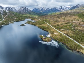 Gaularfjell mountain crossing, typical red norwegian house on an island, aerial view, national