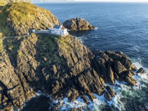 Aerial view of Krakenes Fyr lighthouse, lighthouse located on steep cliff, norwegian coast north of