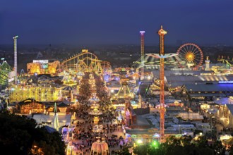 Street of beer tents, main street at night with illuminated roller coaster, Ferris wheel, stalls,