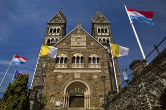 Roman Catholic parish church in Clerf with church flag and Luxembourg flag, Duchy of Luxembourg