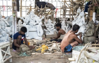 Artisan work on idols of the elephant-headed Hindu deity Ganesha at a workshop ahead of the Ganesh