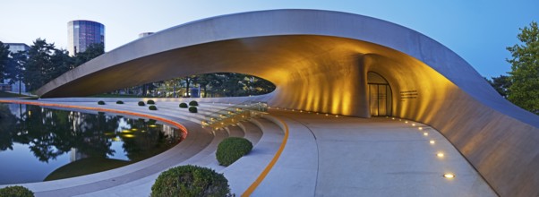 Illuminated Porsche Pavilion in the evening, Autostadt, Volkswagen AG, Wolfsburg, Lower Saxony,