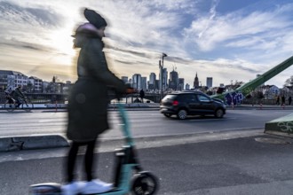 Skyline of Frankfurt am Main, skyscrapers, e-scooter rider on the Flößerbrücke, Hesse, Germany,