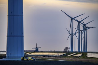 Windmill Poldermolen De Goliath stands between the high-tech wind turbines in Eemshaven, historic