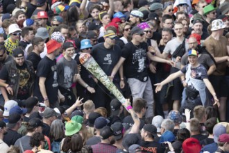 Adenau, Germany, 7 June 2024: Fans with a fake joint during the first day of Rock am Ring. The