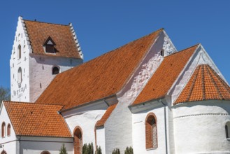 Lindelse Kirke, typical Danish church from 1830, whitewashed, red tiled roof, hill, steeple with