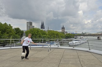 A ten-year-old boy playing with his football, viewing platform of the Chocolate Museum, Cologne,