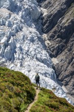 Mountaineer on a hiking trail in front of a glacier, glacier tongue Glacier de Taconnaz, Chamonix,