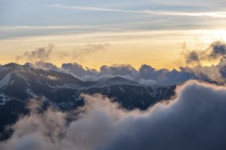 Mountain landscape at sunset, clouds around mountain peaks, Chamonix, Haute-Savoie, France, Europe