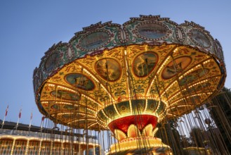 Illuminated historical carousel, dusk, Tivoli Amusement and Recreation Park, Copenhagen, Denmark,