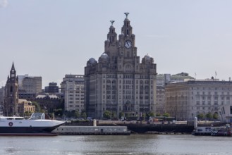 Famous historic building next to a large ship on the river, Liverpool