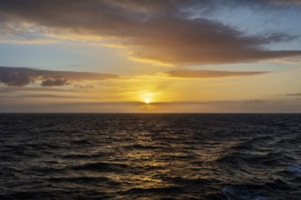 Peaceful sunset over the sea with bright orange sky and clouds, Celtic Sea