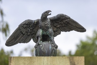 Eagle with globe, sculpture, artwork at a courtyard entrance in Stuttgart, Baden-Württemberg,