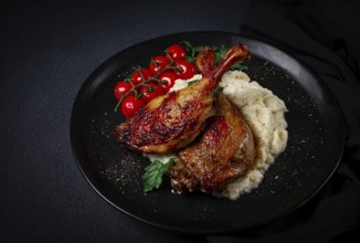 Fried duck shank, cauliflower puree, cherry tomatoes, homemade, no people