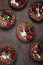 Chocolate tartlets, stuffed with cottage cheese and berries, breakfast, homemade, no people